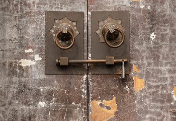 Traditional Chinese bronze handle on brown door. Oriental architecture background