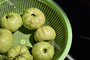 guava fruits in green basket