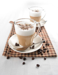 hot cafe coffee latte with bubble layer and coffee bean on white background halal beverage menu