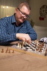 dad teaches his daughter to play chess