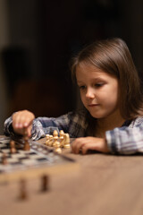 dad teaches his daughter to play chess
