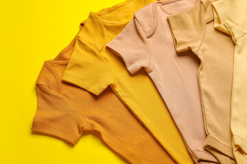Baby clothes on color background