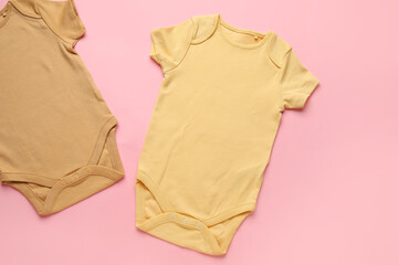 Baby clothes on color background