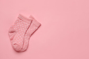 Baby socks on color background