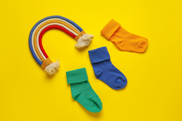 Baby socks on color background