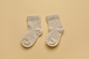 Baby socks on color background
