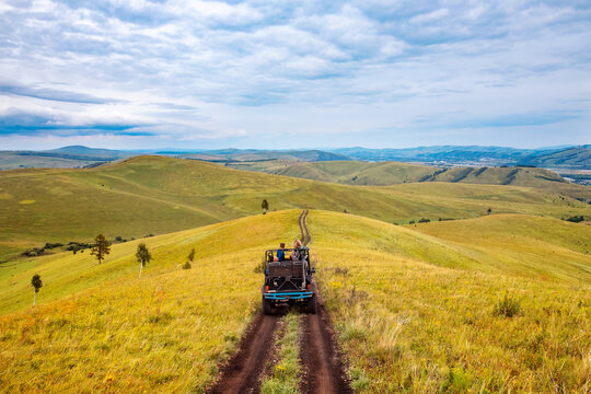 Fototapeta Car ATV tour mountains of Russia Altay travel to national parks safari trip or savannah