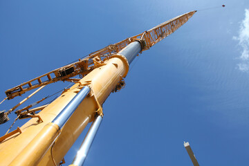 Crane towards the sky. Construction site.