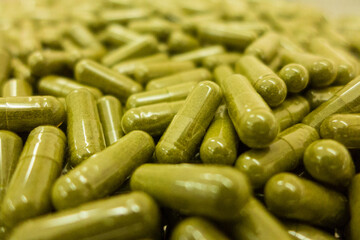 Green powdered substance on a soft gel capsule