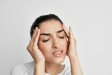 woman holding her head migraine health problems dissatisfaction
