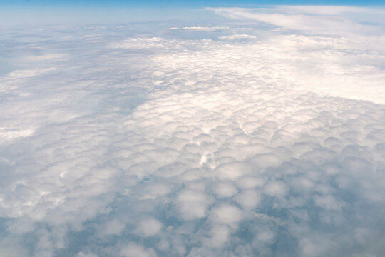beautiful view of the fluffy clouds from the airplane window