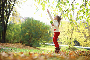 Obraz na płótnie Canvas Children for a walk in the autumn park. Leaf fall in the park. Family. Fall. Happiness.