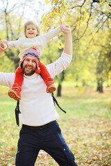 Fototapeta premium Children for a walk in the autumn park. Leaf fall in the park. Family. Fall. Happiness.