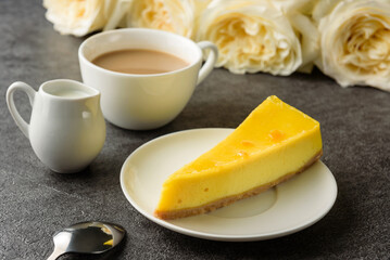 Fototapeta premium lemon cheesecake with coffee close-up.