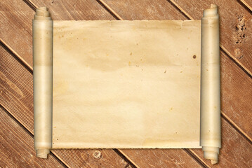 Scroll of old parchment on vintage wooden boards