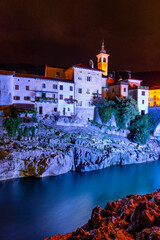 medieval town on Soca river at night