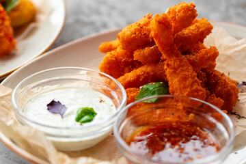 Deep fried shrimps served with sauce on plate