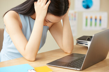Portrait of beautiful business woman is stressed while working in the office because multitasking...