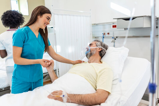 Healthcare concept of professional doctor consulting and comforting elderly patient in hospital bed or counsel diagnosis health. Medical doctor or nurse holding senior patient's hand