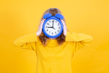 woman with alarm clock in front of face