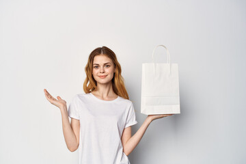 woman with white package in hands lifestyle shopping fun
