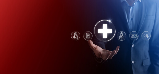 Businessman hold virtual plus medical network connection icons. Covid-19 pandemic develop people awareness and spread attention on their healthcare.Doctor,document,medicine,ambulance,patient icon.