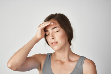 Obraz premium woman in gray t-shirt holding her head depression migraine stress