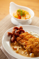 Chicken curry and fried sausage