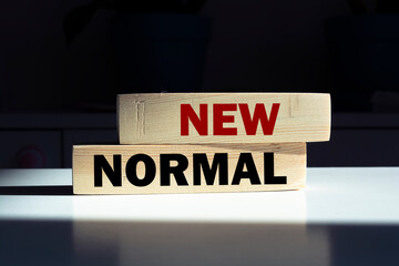 Blocks with NEW NORMAL word. Adapting to new life or business post-lockdown after coronavirus pandemic. Business with social distancing personal hygiene.