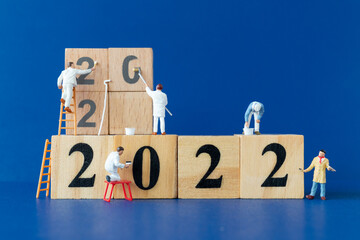 Miniature people worker team painting number 2022 , Happy new year concept