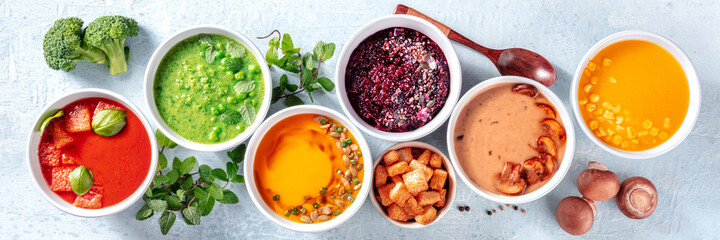 Vegan soup assortment panorama with many different cream soups, fresh summer detox menu, overhead flat lay panoramic banner
