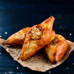 russian pie rasstegay with a hole on top, Traditional Russian, Slavic pies with hole in center. Rasstegay on wooden background © smspsy