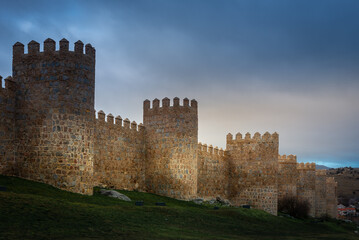 Fototapeta na wymiar Medieval city wall built in the Romanesque style, Avila in Spain 
