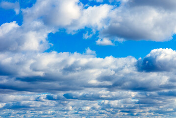 Dramatic blue sky with white clouds background.