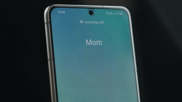 Close Up Smartphone Screen With Incoming Call Indication. Incoming Call From Mom