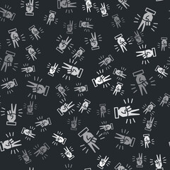 Grey Hand showing two finger icon isolated seamless pattern on black background. Victory hand sign. Vector