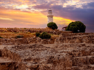 Cyprus landscape. Lighthouse on banks of city of Paphos. White lighthouse next to medieval ruins....