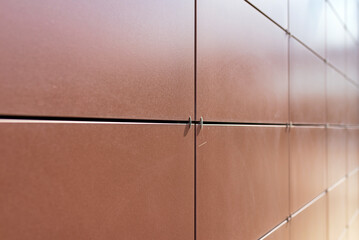 Background texture of rectangular smooth brown tiles. Stone street covering of wall, masonry of building.