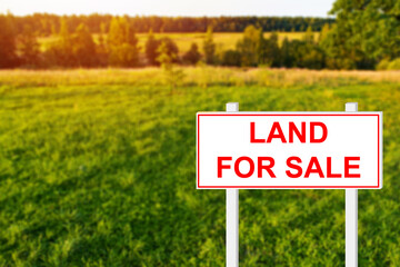 Land for sale sign. Real estate conceptual image. White sign symbolizes sale of building plot....