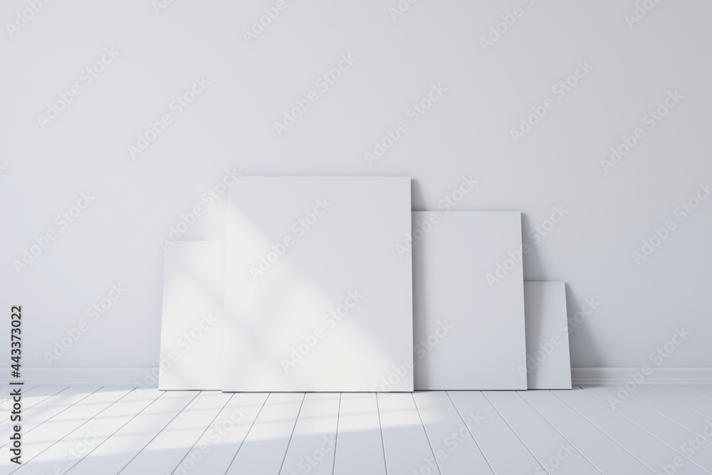 Poster blank canvases of paintings in an empty white room. 3d rendering