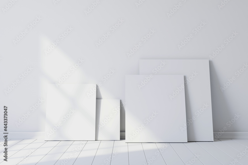 Poster blank canvases of paintings in an empty white room. 3d rendering
