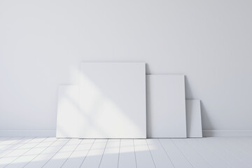 Blank canvases of paintings in an empty white room. 3d rendering