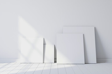 Fototapeta premium Blank canvases of paintings in an empty white room. 3d rendering