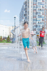 Bathing in fountains, children run around having fun from splash