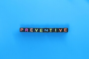 small black cubes with the word preventive colored