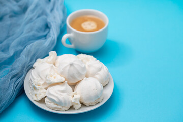 cup of coffee with meringues on white dish
