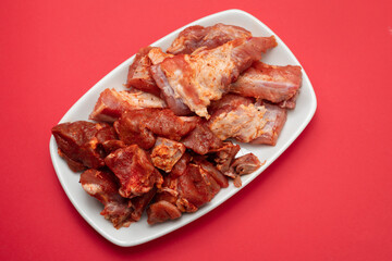 marinated raw meat and ribs on white dish