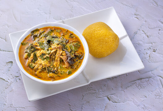 Oha or Ora Soup with Garri on a white plate