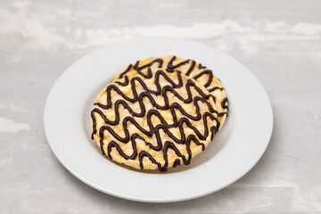 corn crackers with lines of chocolate on white plate