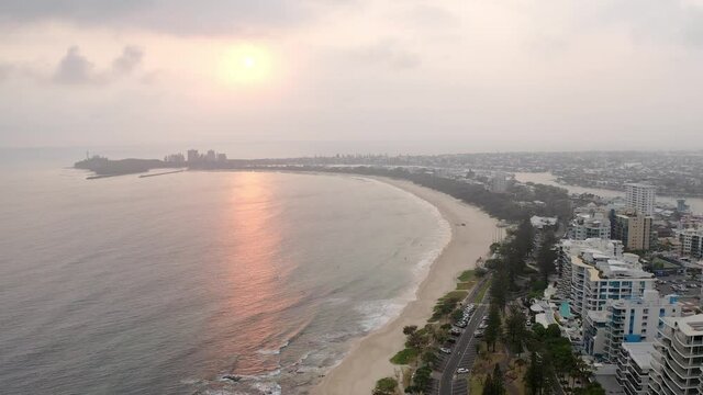 Landscape View of Mooloolaba Beach with Beachfront Resort and Landmarks in QLD, Australia on Sunset. Port Cartwright Beach and Lighthouse at the Background. aerial